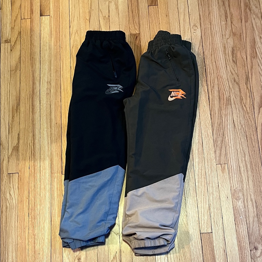 Two pairs of Nike Kids' Black & Gray and Olive & Tan Joggers size 10-12 Medium